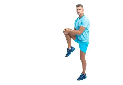Man runner warming up and stretching muscle before workout isolated on white Stock Photos