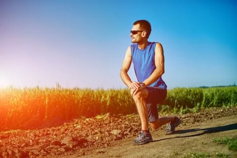 Man runner warming up before jogging Stock Photos