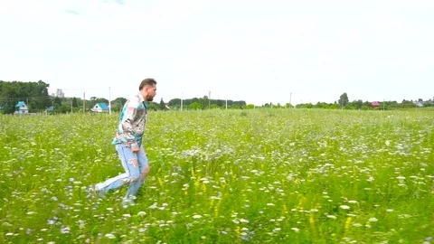 Man is runnig across the field Stock Footage 79604726