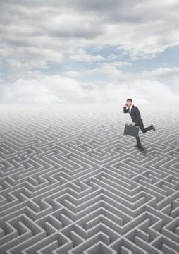 Man running on a 3d maze with clouds Foto stock