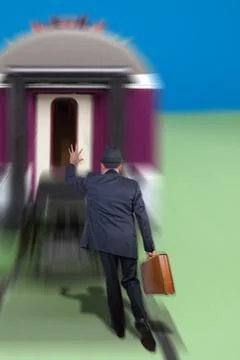 Man running after a train Stock Photos