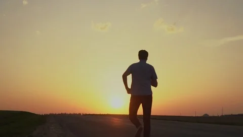 A man is running against the sunset. Stock Footage 89382842