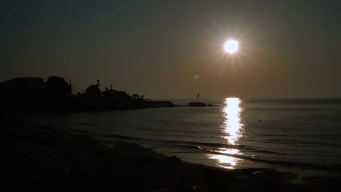 A man is running along the beach at sunset. 動画素材 79993470