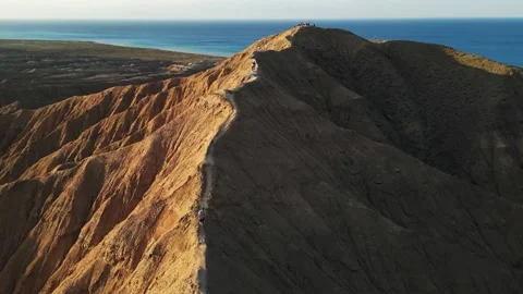 Man running along the ridge of a mountain Issyk-kul region Kyrgyzstan. Stock Footage 328408935