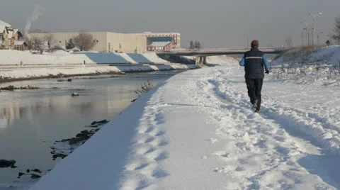 Man running along the river Stock Footage 14925057