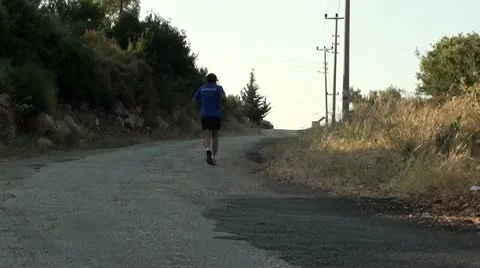 A man is running along road Stock Footage 10763868