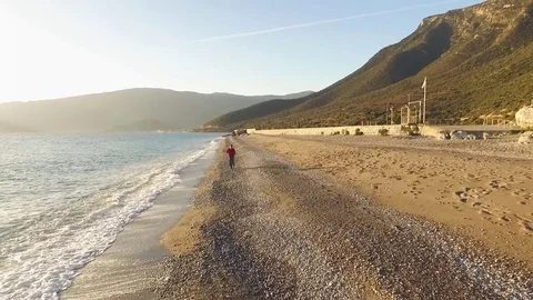 Man running along the seashore Stock Footage 72148637