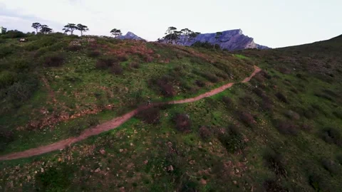 Man running along the side of a mountain  Stock Footage 338227781