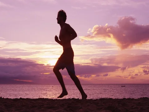 Man running and jogging training at beach sunrise Stock Footage 76831197