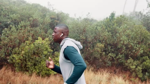 Man, running and mountain for exercise sports in raining weather for commitment 動画素材 270781091