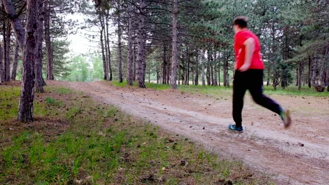 The man is running around the forest trail. 스톡 동영상 89967853
