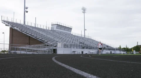 Man running around track Stock Footage 65879387