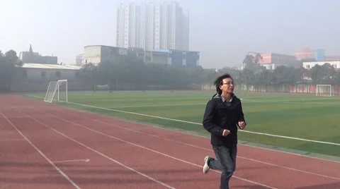 Man running on the athletic track Stock Footage 45053917