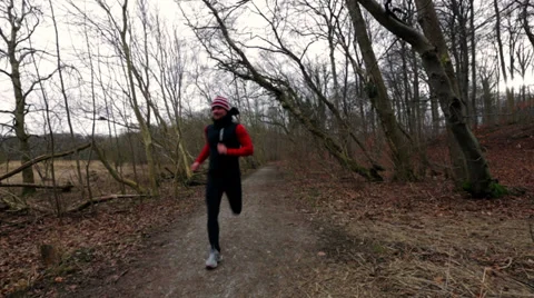 Man running in a autumn forest Stock Footage 36070988