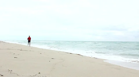 Man Running on the Beach Stock Footage 33577891