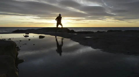 Man running on beach Stock Footage 43308307