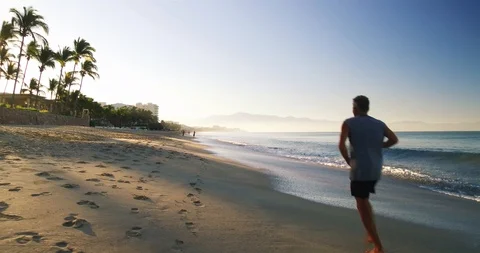 Man running on a beach.  Stock Footage 102689430