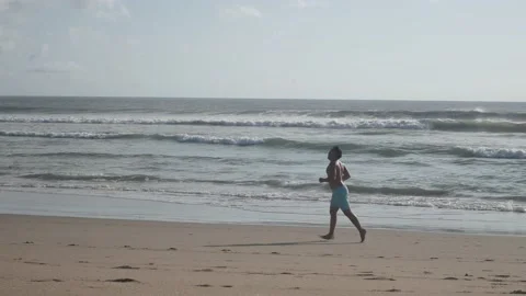 Man running on the beach Stock Footage