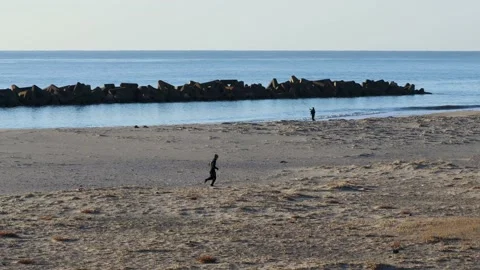 Man running on the beach Stock Footage 237445093