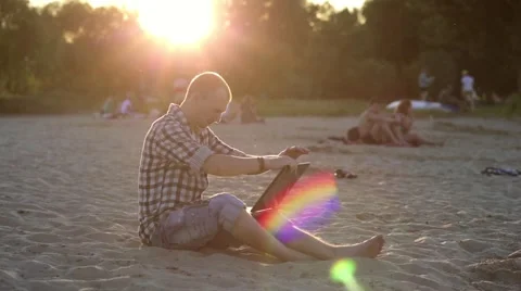 Man running on the beach with a laptop Stock Footage 52076875