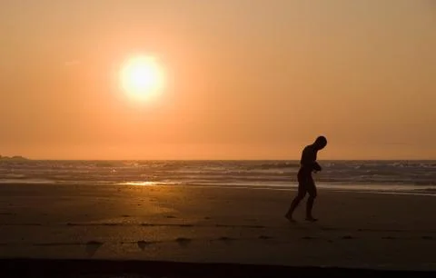 Man running on the beach Stock Photos