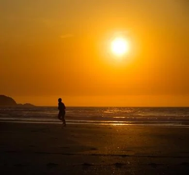 Man running on the beach Stock Photos