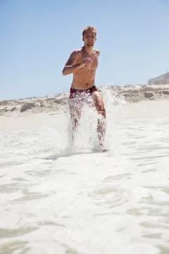 Man running on the beach Stock Photos