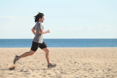 Man running on the beach Stock Photos
