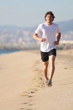 Man running in the beach Stock Photos