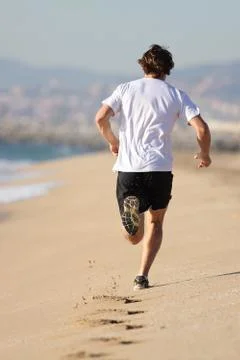 Man running in the beach Stock Photos