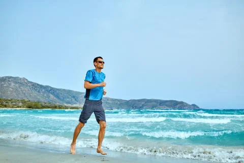 Man running on the beach Stock Photos