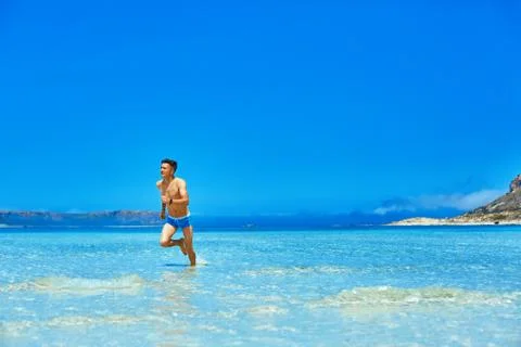 Man running on the beach Stock Photos