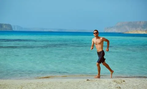 Man running on the beach Stock Photos
