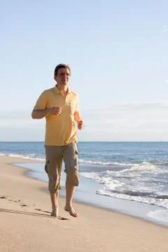 Man running on the beach Фото