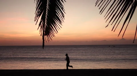 Man running on beach in sunrise Video stock 53104435