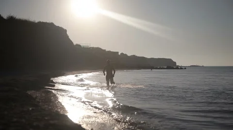 Man running on beach at sunrise. Stock Footage 66782812