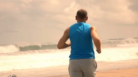 Man running on beautiful beach, super slow motion Stock Footage 71364937