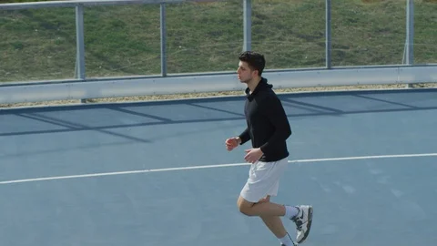 Man running on a blue track Stock Footage 100029712