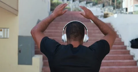 Man running in the city while listening music outdoor Stock Footage 154194195