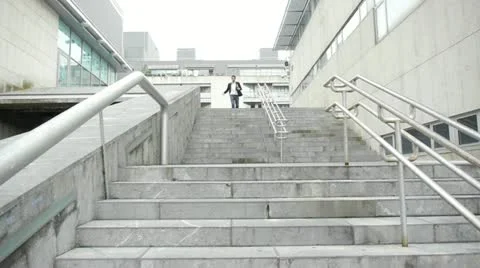 Man running down stairs in town Stock-Footage 14830121