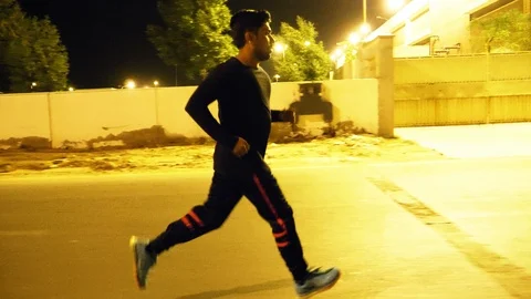 Man running in an empty road Stock Footage 93458854