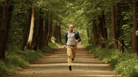 Man running fast forward. career progress. young male person. green park Stock Footage 40741235