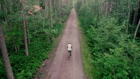 Man running in forest, drone shot. Stock Footage 278733060