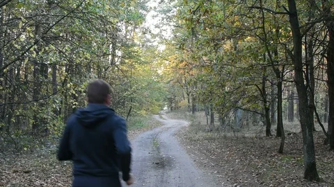 Man is running in the forest  Stock Footage 96442462