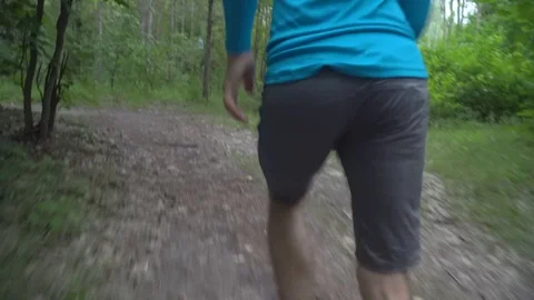 Man running in forest, rear view Video stock 117365760