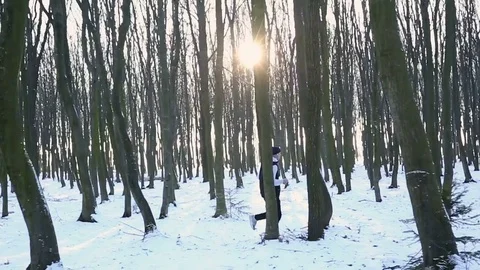 Man running in the forest in winter time. Stop after a long jog Stock Footage 77035795