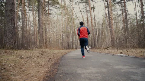 Man running in forest woods training Stock Footage 62253904