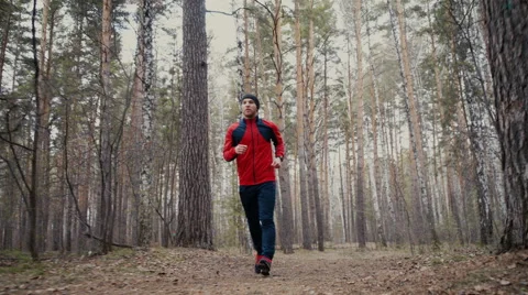 Man running in forest woods training and look at smart watches. Stock Footage 62255235