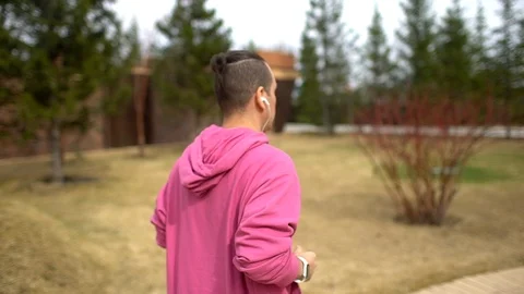 Man running in forest woods training and look at smart watches. Stock Footage 89407403