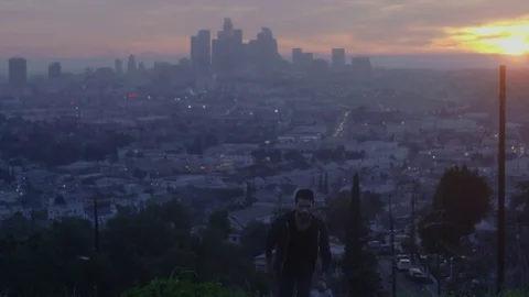 Man Running Up Hill At Sunset Skyline Los Angeles 2 Video stock 78993113